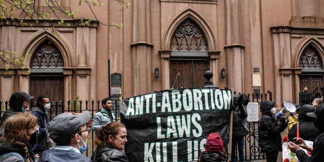 Abortion rights activists gather outside of a Catholic church in downtown Manhattan to voice their support for a woman's right to choose on May 7, 2022, in New York City.