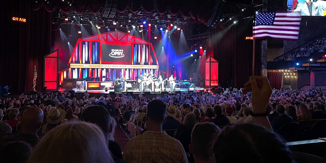 An American flag waves as Dailey &安培; Vincent perform at the Grand Ole Opry in Nashville, 田纳西州, 在5月 24, 2022.