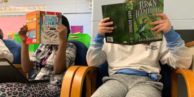 Elementary school students read books donated by O3 Books. (Pathik Oza/O3 Books)