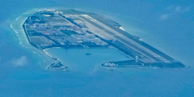 Chinese structures and buildings on the man-made Fiery Cross Reef at the disputed Spratlys group of islands in the South China Sea are seen on March 20, 2022. 