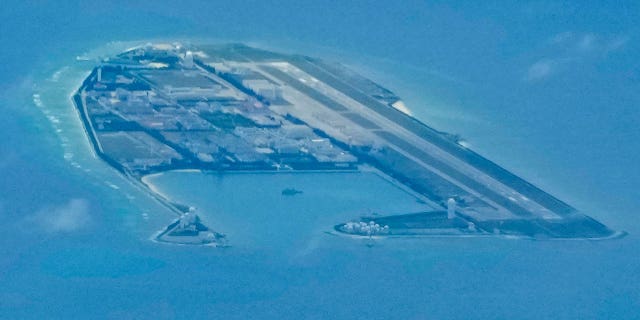 Chinese structures and buildings on the man-made Fiery Cross Reef at the disputed Spratlys group of islands in the South China Sea are seen on March 20, 2022. 