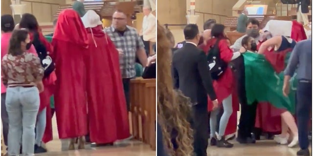 Red-clad protesters interrupt a Sunday Mass at at the Cathedral of Our Lady of the Angels in downtown Los Angeles.