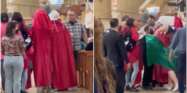 Red-clad protesters interrupt a Sunday Mass at at the Cathedral of Our Lady of the Angels in downtown Los Angeles.
