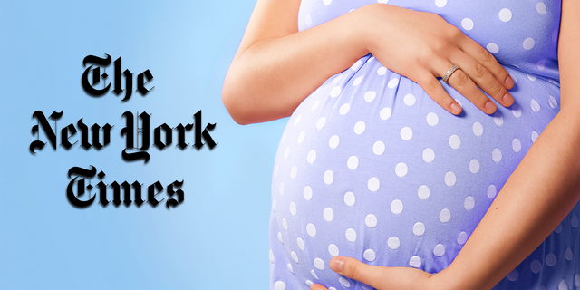 A pregnant woman clutching her unborn baby.