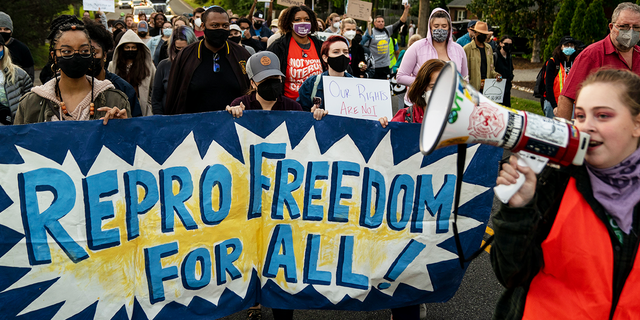 Abortion-rights advocates mach in the street to stage a protest outside the house of Supreme Court Associate Justice Samuel Alito in the Fort Hunt neighborhood on Monday, May 9, 2022 in Alexandria, VA. (Kent Nishimura / Los Angeles Times via Getty Images) 