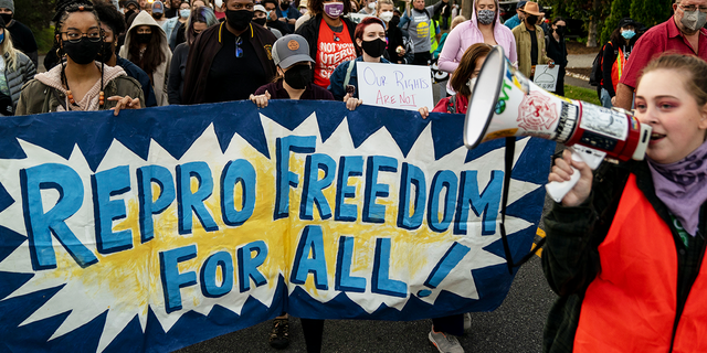 ALEXANDRIA, VA - MAY 09: Abortion-rights advocates mach in the street to stage a protest outside the house of Supreme Court Associate Justice Samuel Alito in the Fort Hunt neighborhood on Monday, May 9, 2022 in Alexandria, VA. (Kent Nishimura / Los Angeles Times via Getty Images) 