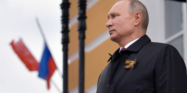 Russian President Vladimir Putin watches an air parade on Victory Day, which marks the anniversary of the victory over Nazi Germany in World War Two, amid the outbreak of the coronavirus disease (COVID-19) in central Moscow, Russia May 9, 2020.