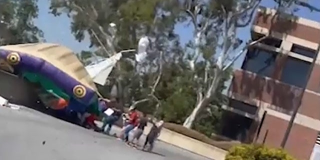 Three children suffered injuries when a bounce house they were inside was lifted into the air by a sheriff's helicopter flying overhead, police said.
