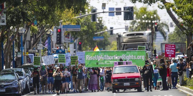 Abortion rights supporters and activists from Rise Up 4 Abortion Rights LA march on Santa Monica Boulevard on Saturday, May 7, 2022, in West Hollywood, California.