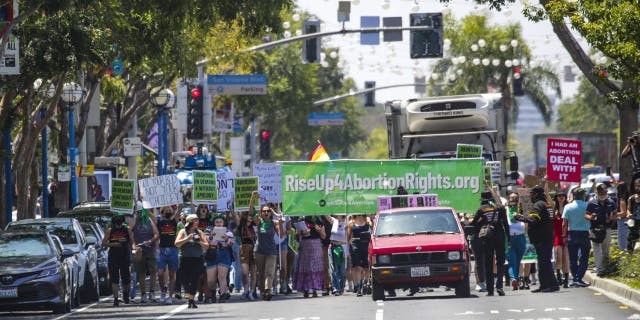 Abortion rights supporters and activists from Rise Up 4 Abortion Rights LA march on Santa Monica Boulevard on Saturday, May 7, 2022, in West Hollywood, California.