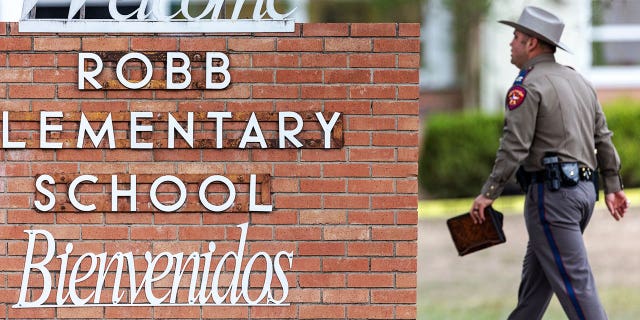 A state trooper walks past the Robb Elementary School sign in Uvalde, Texas, on Tuesday, May 24, 2022, following a deadly shooting at the school.