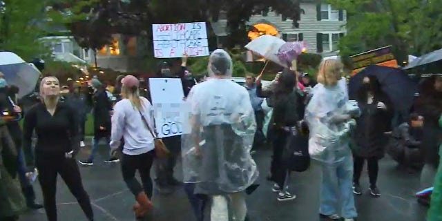 Protestors stand outside of conservative Supreme Court justices' homes to object to Roe v. Wade overturn.