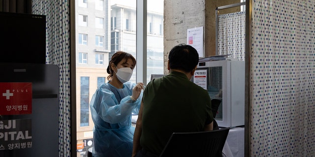 A nurse administers a booster shot of the Moderna Inc. Covid-19 vaccine at the H Plus Yangji Hospital in Seoul, South Korea, on Thursday, Dec. 16, 2021. 