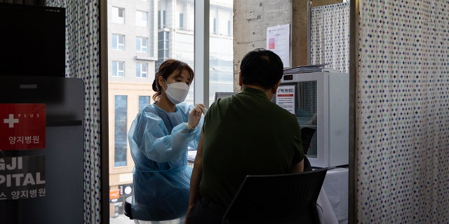 A nurse administers a booster shot of the Moderna Inc. Covid-19 vaccine at the H Plus Yangji Hospital in Seoul, South Korea, on Thursday, Dec. 16, 2021. 