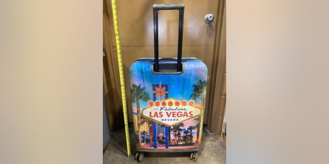 The boy's body was discovered inside a  hard suitcase with a Las Vegas design.