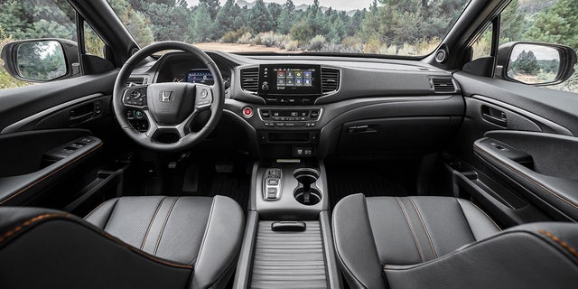 The Passport TrailSport cabin has orange-stitched upholstery.