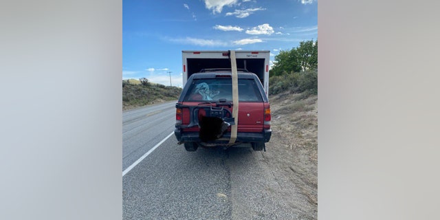 A single packing strap was securing the car inside the back of the truck.