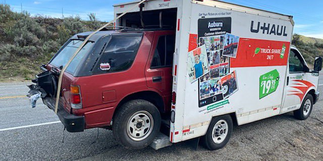 A Washington state trooper pulled over the driver of a U-Haul truck that was hauling a car crammed into the back.