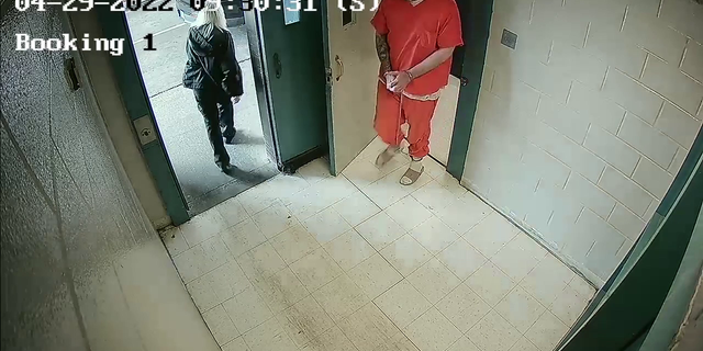 Surveillance cameras inside recorded Vicky White opening a steel door and, without looking back, holding it for Casey White, who slips out with his head down, dodging it as it swings closed. The two vanish through what looks like an exterior door with a car parked outside.