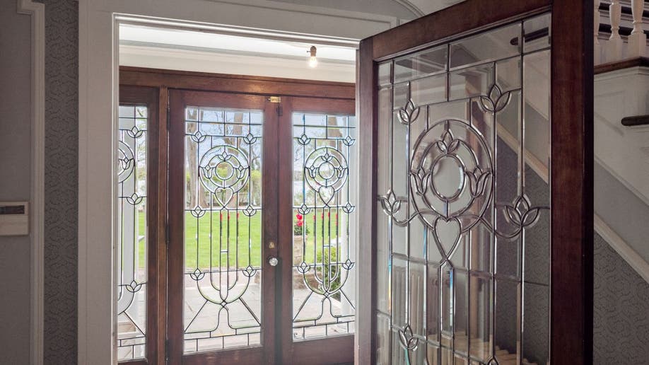 The Smurf House has two sets of leaded beveled glass doors in the front of the home.