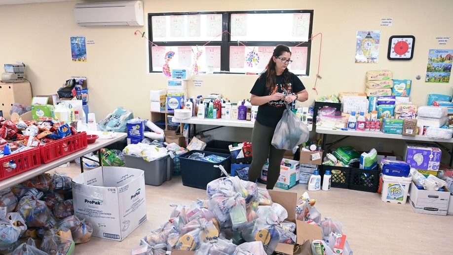 A woman prepares bags at a New Mexico disaster distribution center