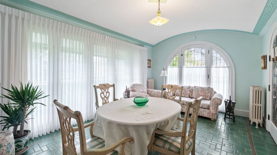 The Smurf house has a blue dining area with arched and square windows.