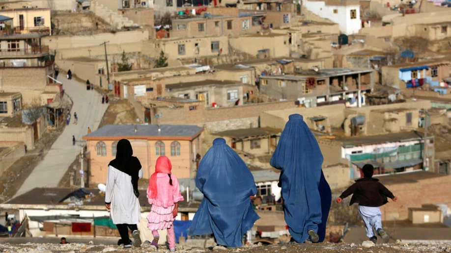 Burqa-clad women walk in Afghanistan