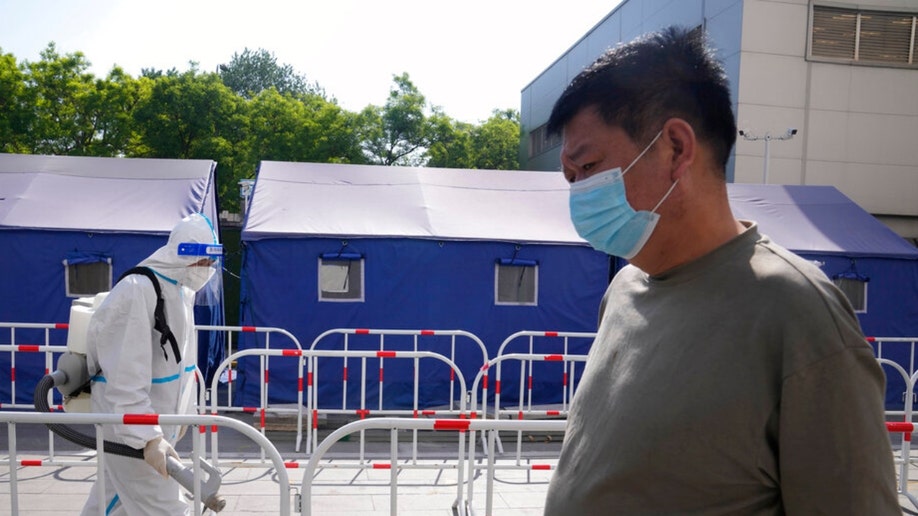A Beijing resident lines up for a COVID-19 test