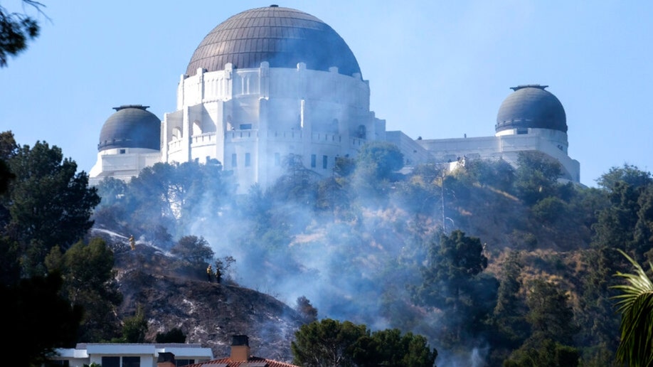 Smoke from a brushfire rises near Los Angeles' Griffith Observatory