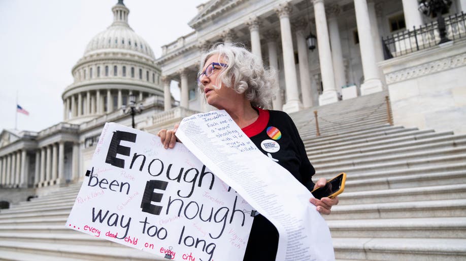 Cindy Nell holding a sign protesting school shootings in front of the U.S. Capitol