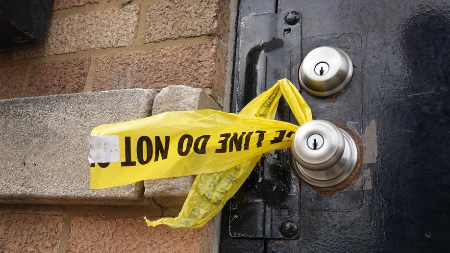 Crime scene tape hangs from a door knob outside of a tow company garage following a shooting where at least 15 people were reported to have been shot, two fatally, on March 14, 2021 in Chicago, Illinois. The shooting took place at a party in an event space attached to the garage in the city's south side Park Manor neighborhood. 