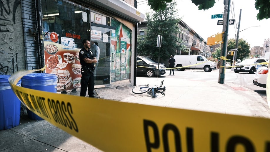 Police converge on the scene of a shooting in Brooklyn, one of numerous during the day, on July 14, 2021 in New York City.