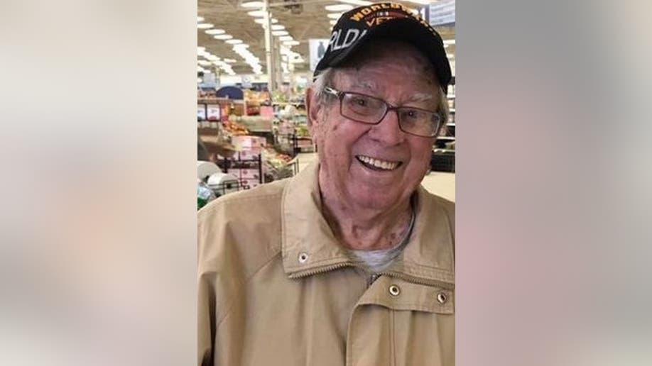 Harold Myers smiles while wearing WWII hat