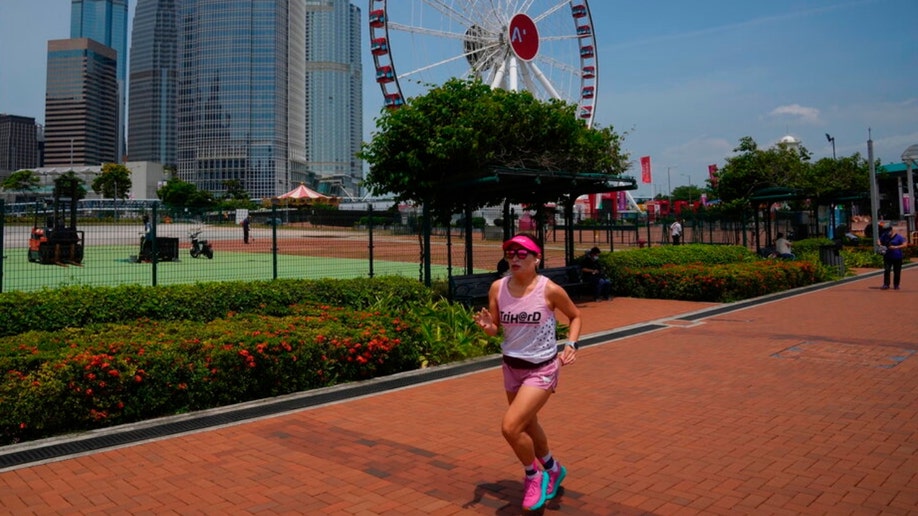 A woman runs at a park in Hong Kong