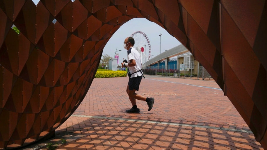 A man runs at a park in Hong Kong