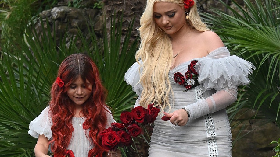 Penelope Disick and Alabama Barker wore matching grey dresses with deep red floral notes