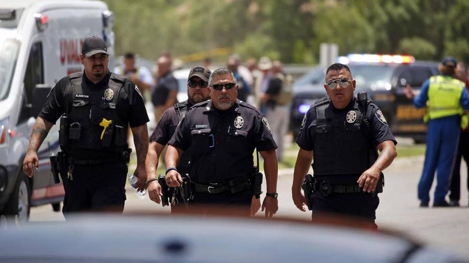 Law enforcement walk after Uvalde Texas elementary school shooting
