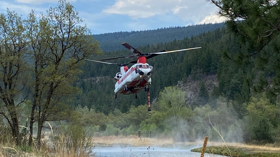 A New Mexico helicopter works to fight the Hermits Peak and Calf Canyon Fires