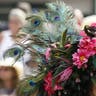 Kentucky Derby hat adorned with flowers and peacock feathers