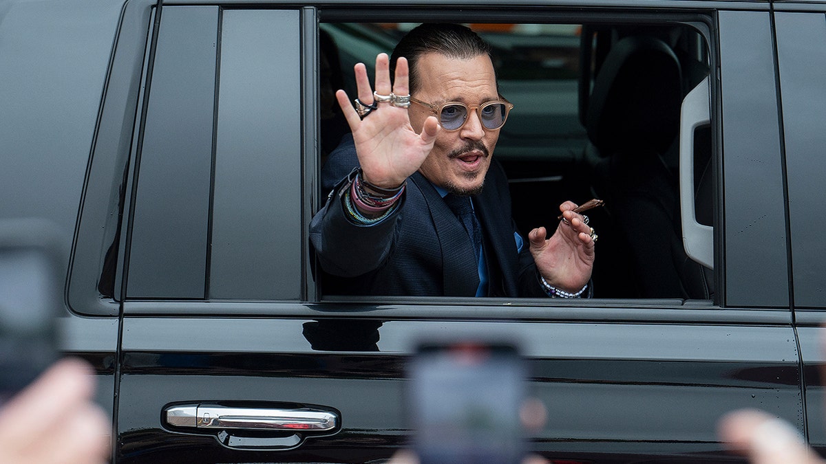 Johnny Depp waves to supporters