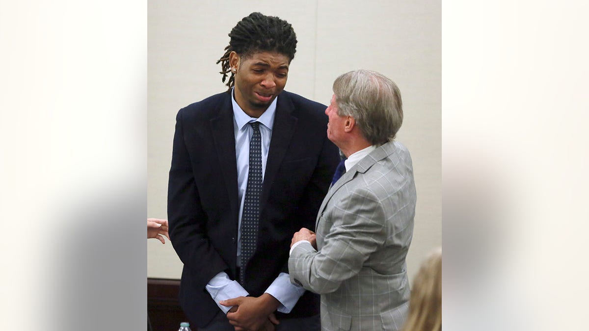 Former Virginia Tech athlete Isimemen Etute cries to defense attorney in court