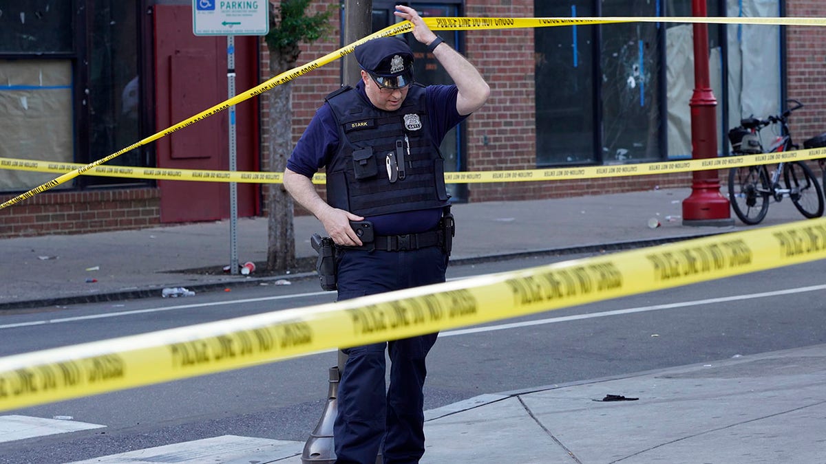 Philadelphia officer and crime scene tape after mass shooting