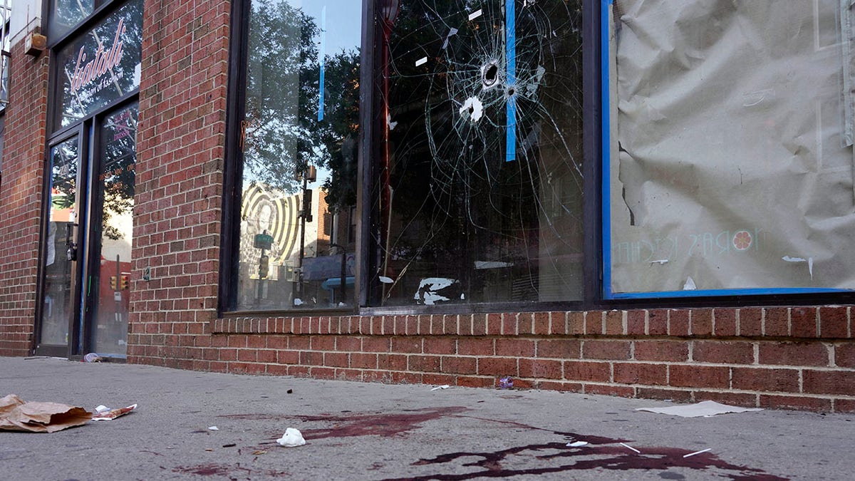 shattered glass and blood on Philadelphia street