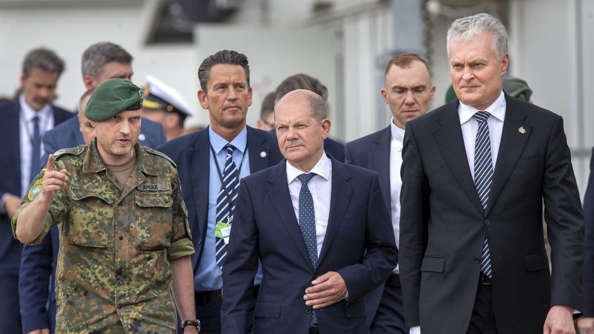 German Chancellor Olaf Scholz speaks at podium