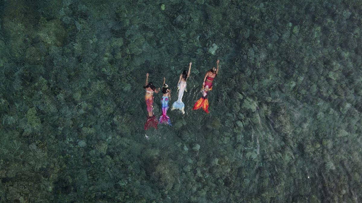 Mermaid instructor Queen Pangke Tabora leads swimming session in ocean