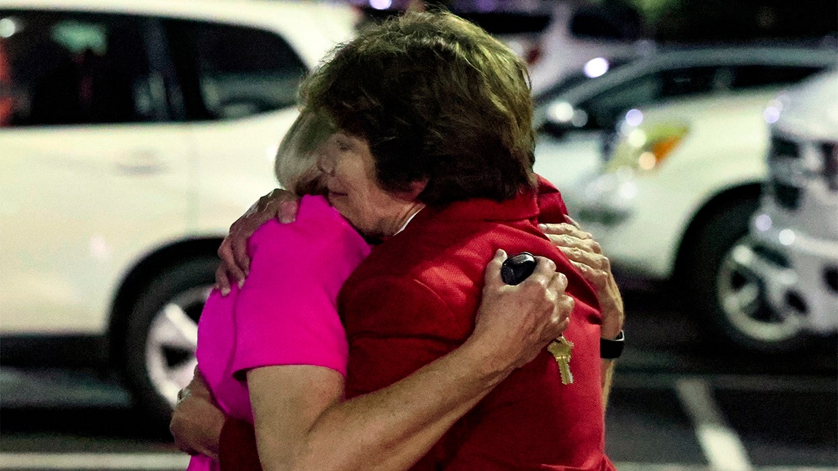 Saint Stephen's Episcopal Church members hug after a shooting in Alabama