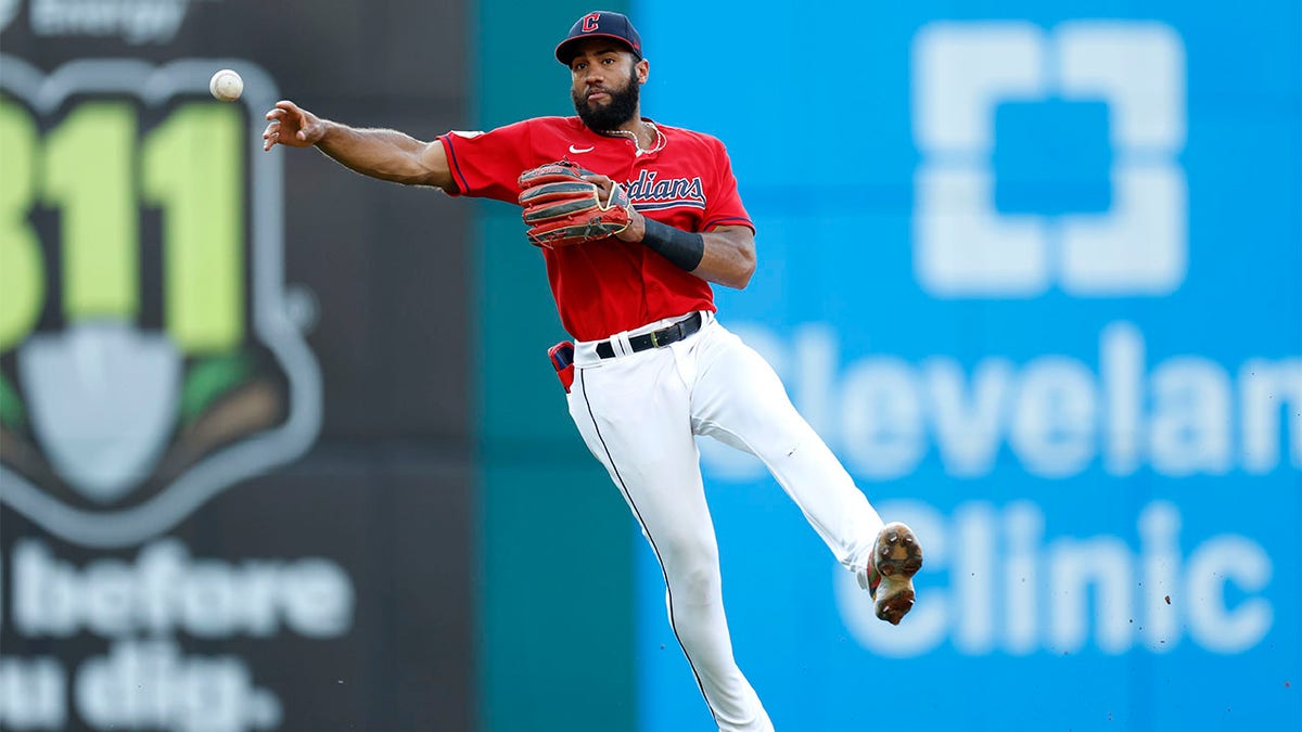 Amed Rosario throws ball to first base