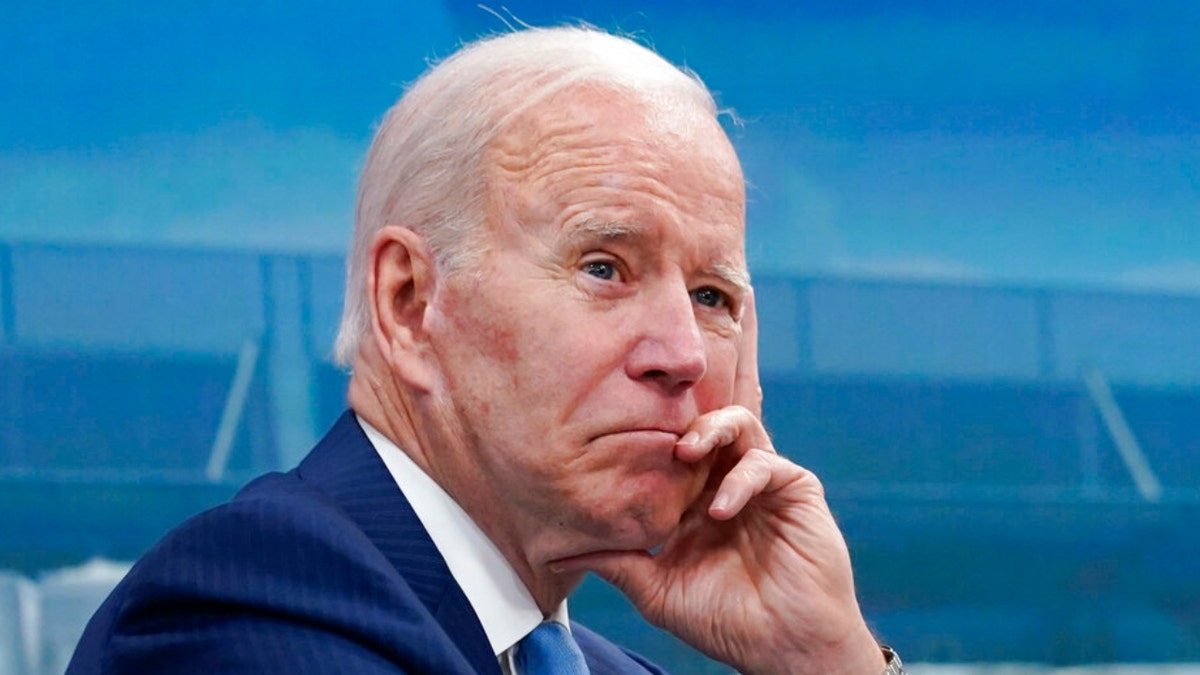President Biden resting his chin in his hand