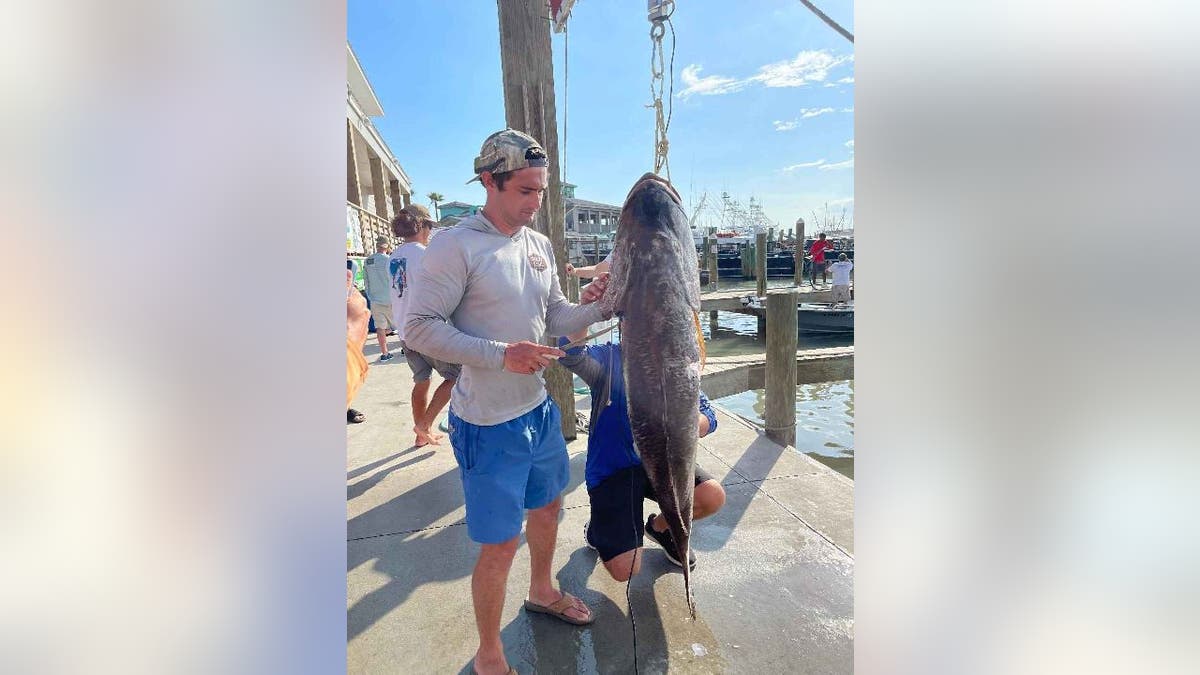 Braden Sherron stands with cubera snapper