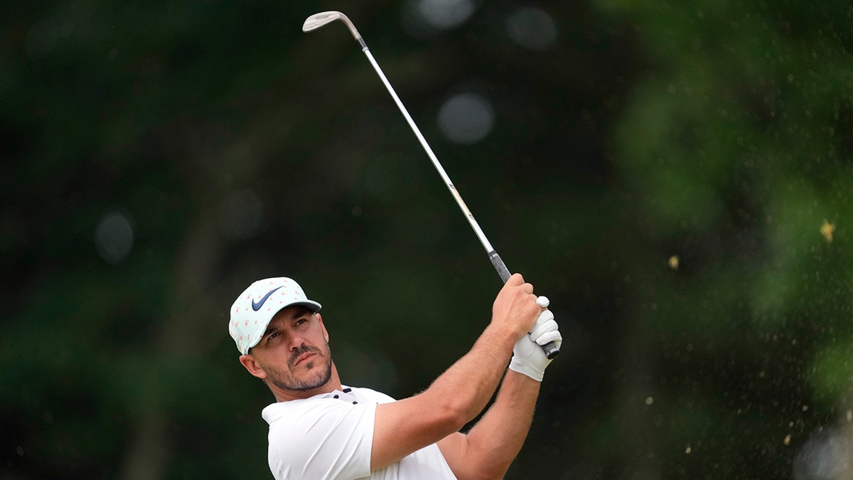 Brooks Koepka watches his shot